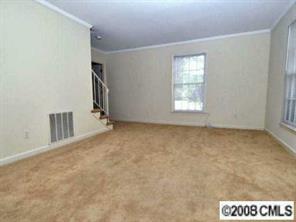 1133 Wimbledon Road Charlotte, NC 28209 - Photo 2 of 8 a view of an empty room with a window