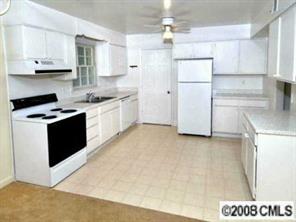 1133 Wimbledon Road Charlotte, NC 28209 - Photo 4 of 8 a kitchen with a refrigerator a stove a microwave and cabinets