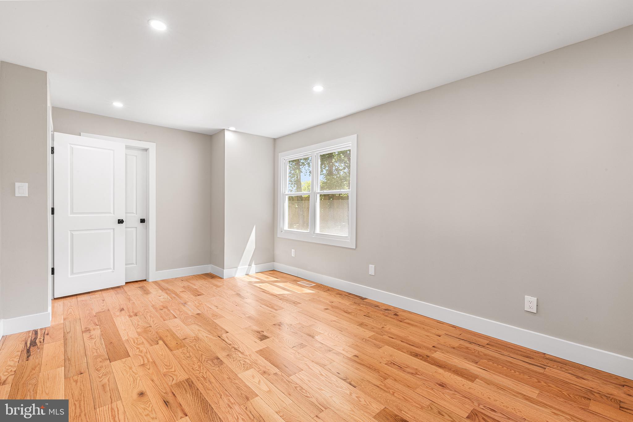 849 Glenn Circle Wayne, PA 19087 - Photo 19 of 36 a view of an empty room with wooden floor and a window