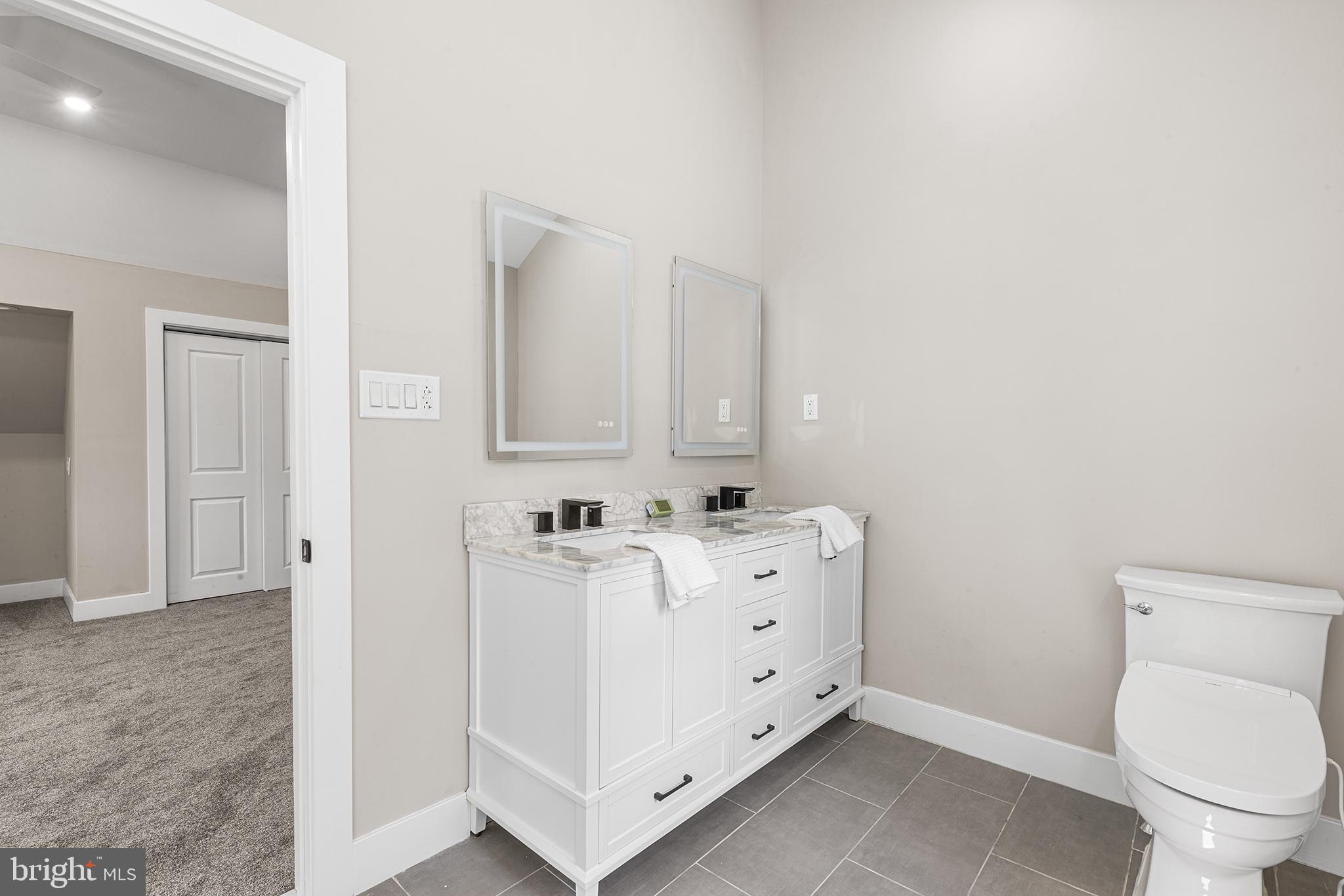 849 Glenn Circle Wayne, PA 19087 - Photo 24 of 36 a bathroom with a toilet sink and mirror
