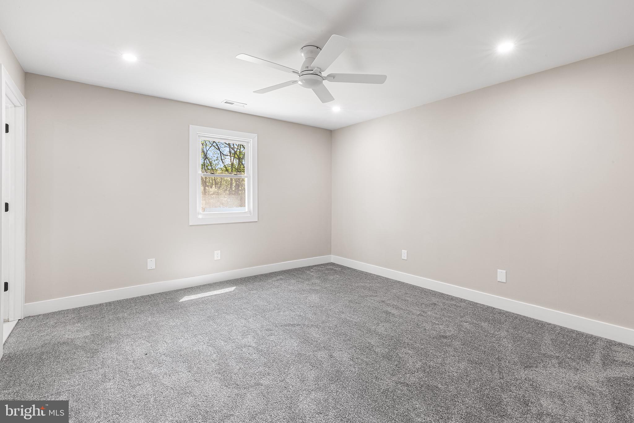 849 Glenn Circle Wayne, PA 19087 - Photo 25 of 36 an empty room with a window and a fan