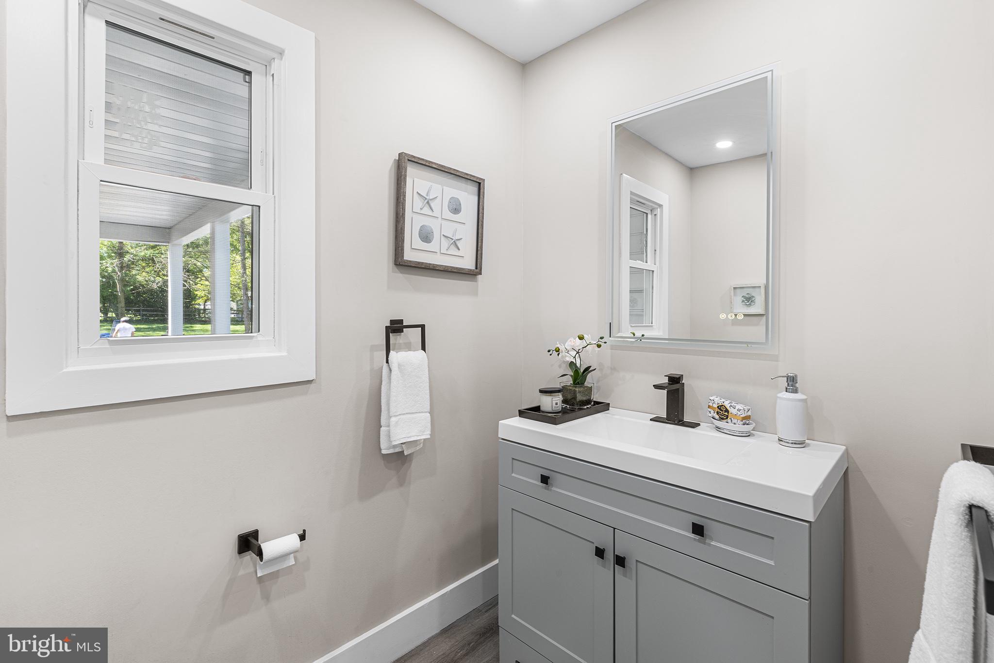 849 Glenn Circle Wayne, PA 19087 - Photo 30 of 36 a bathroom with a sink and a mirror
