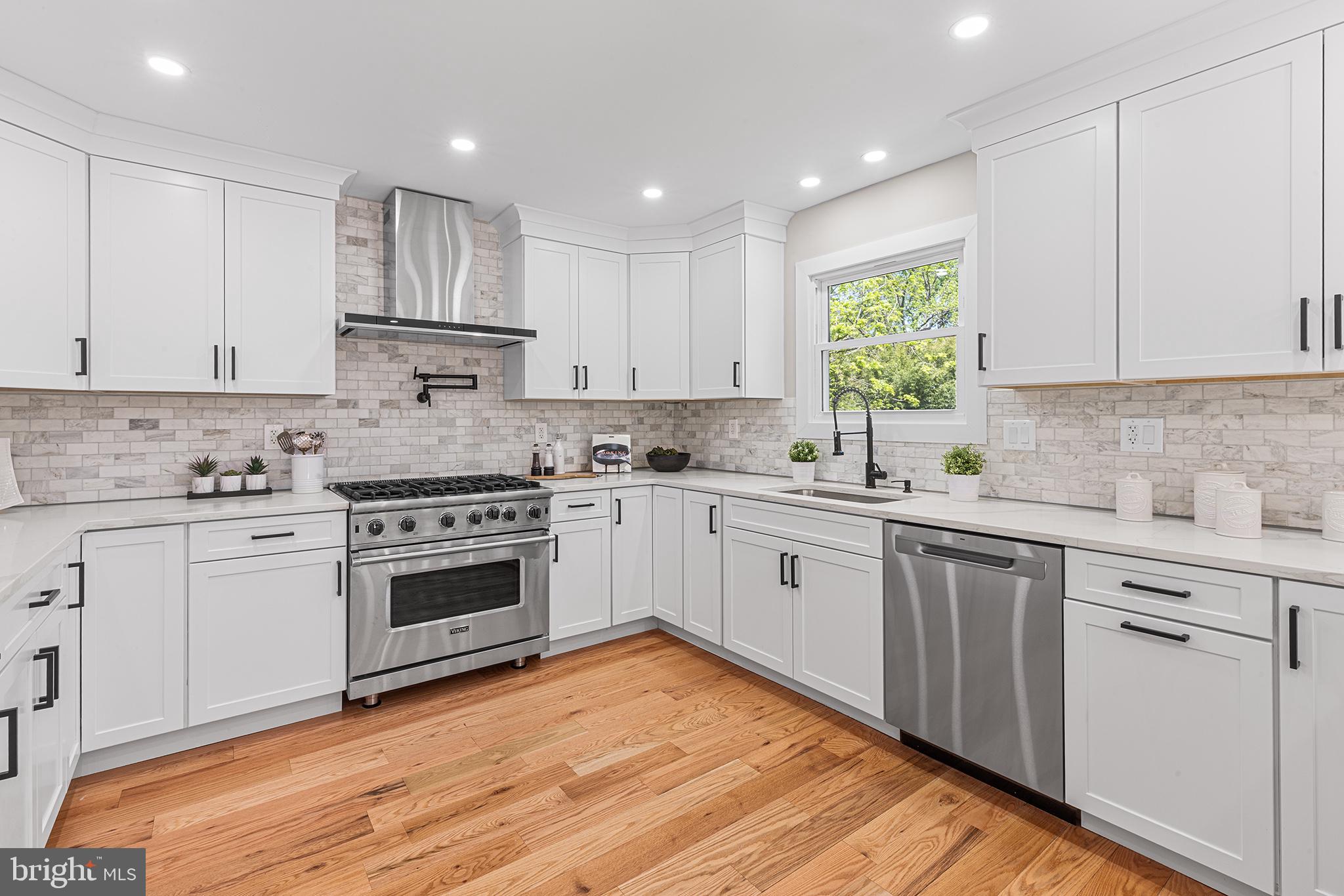 849 Glenn Circle Wayne, PA 19087 - Photo 4 of 36 a kitchen with granite countertop white cabinets and white appliances