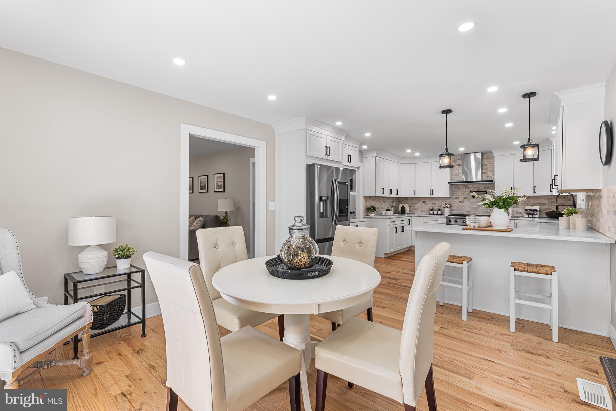 849 Glenn Circle Wayne, PA 19087 - Photo 6 of 36 a dining room with kitchen island a dining table and chairs