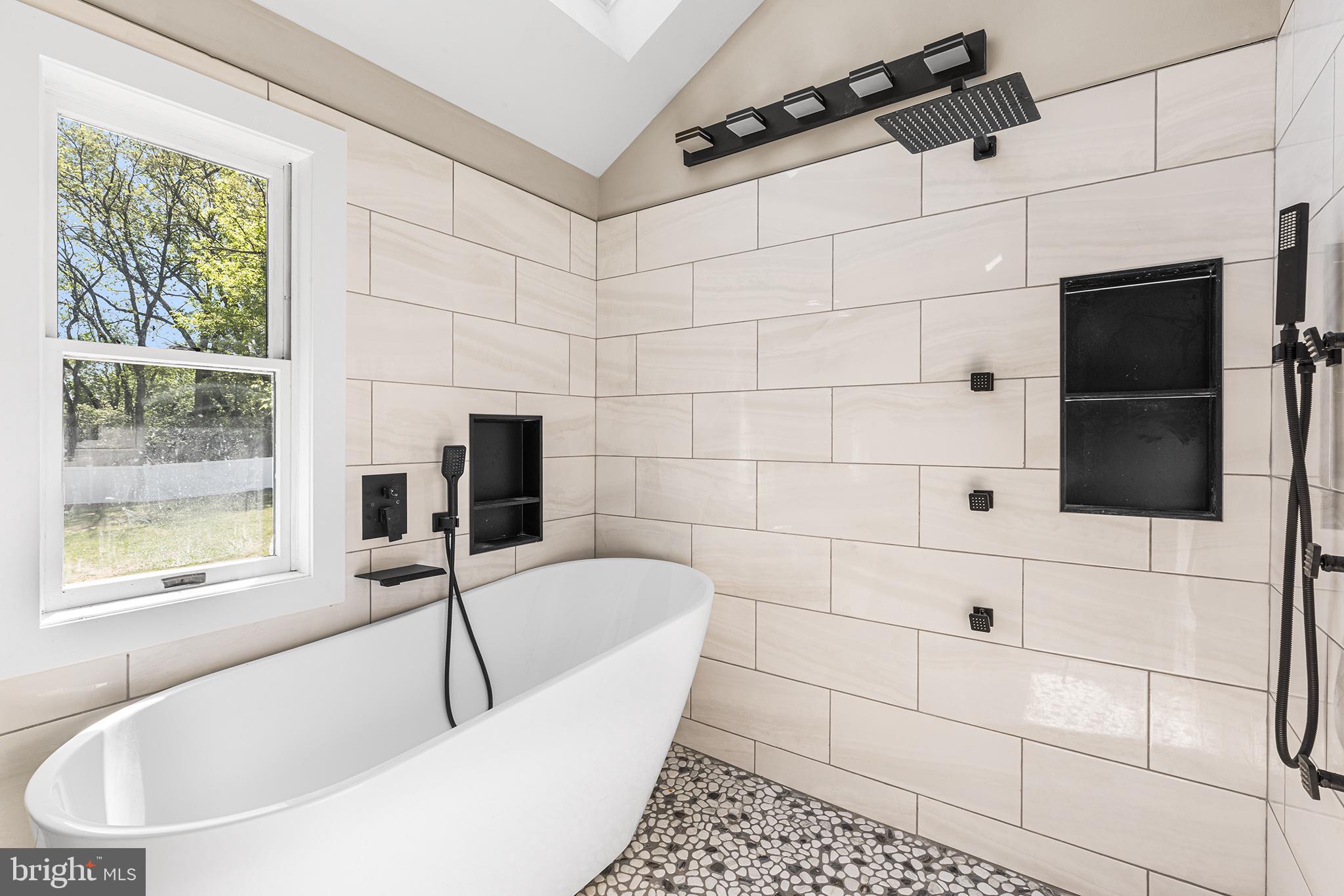 849 Glenn Circle Wayne, PA 19087 - Photo 9 of 36 a bathroom with a bathtub and a shower