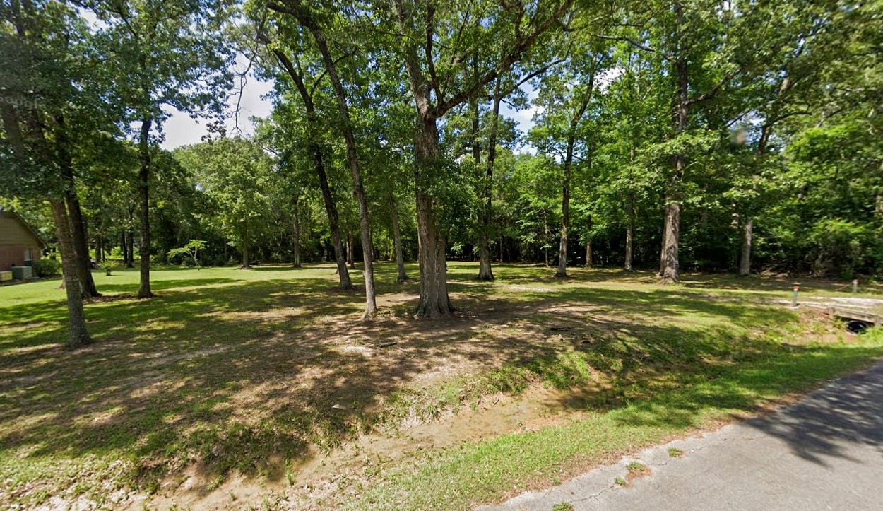 2208 Appian Way New Caney, TX 77357 - Photo 6 of 14 a view of a park with large trees