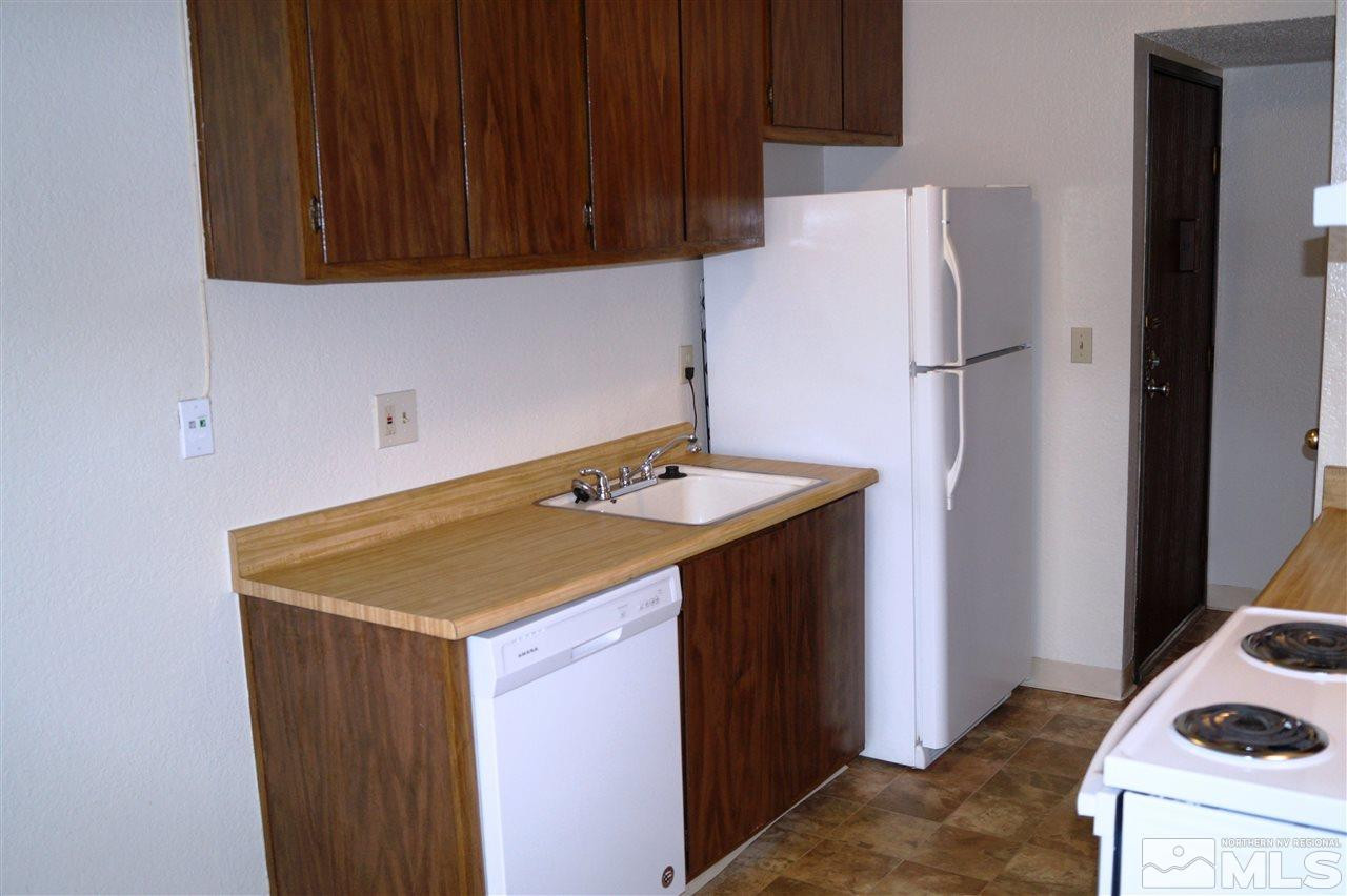 4608 Neil Road, Unit 275 Reno, NV 89502 - Photo 5 of 13 a kitchen with a sink and a refrigerator