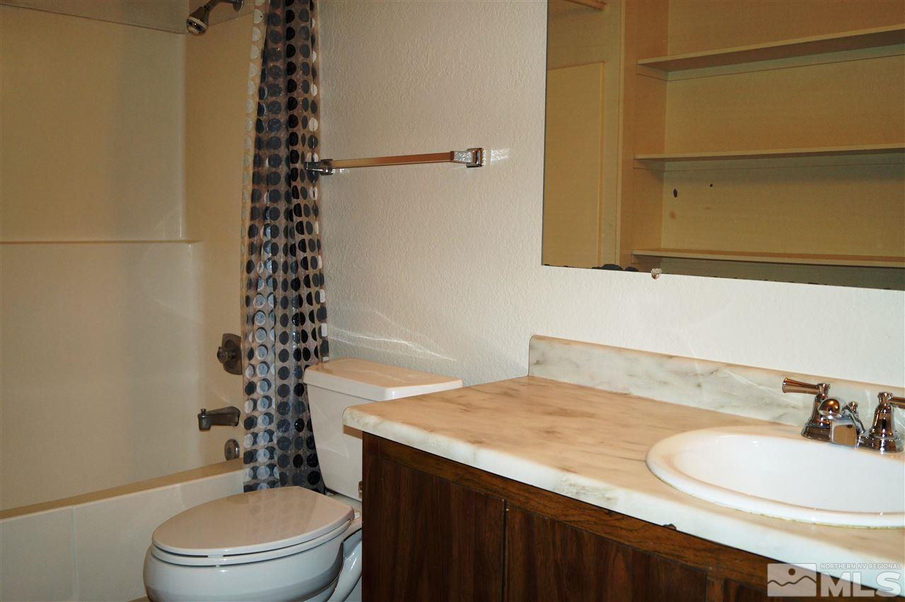 4608 Neil Road, Unit 275 Reno, NV 89502 - Photo 9 of 13 a bathroom with a sink a toilet and shower