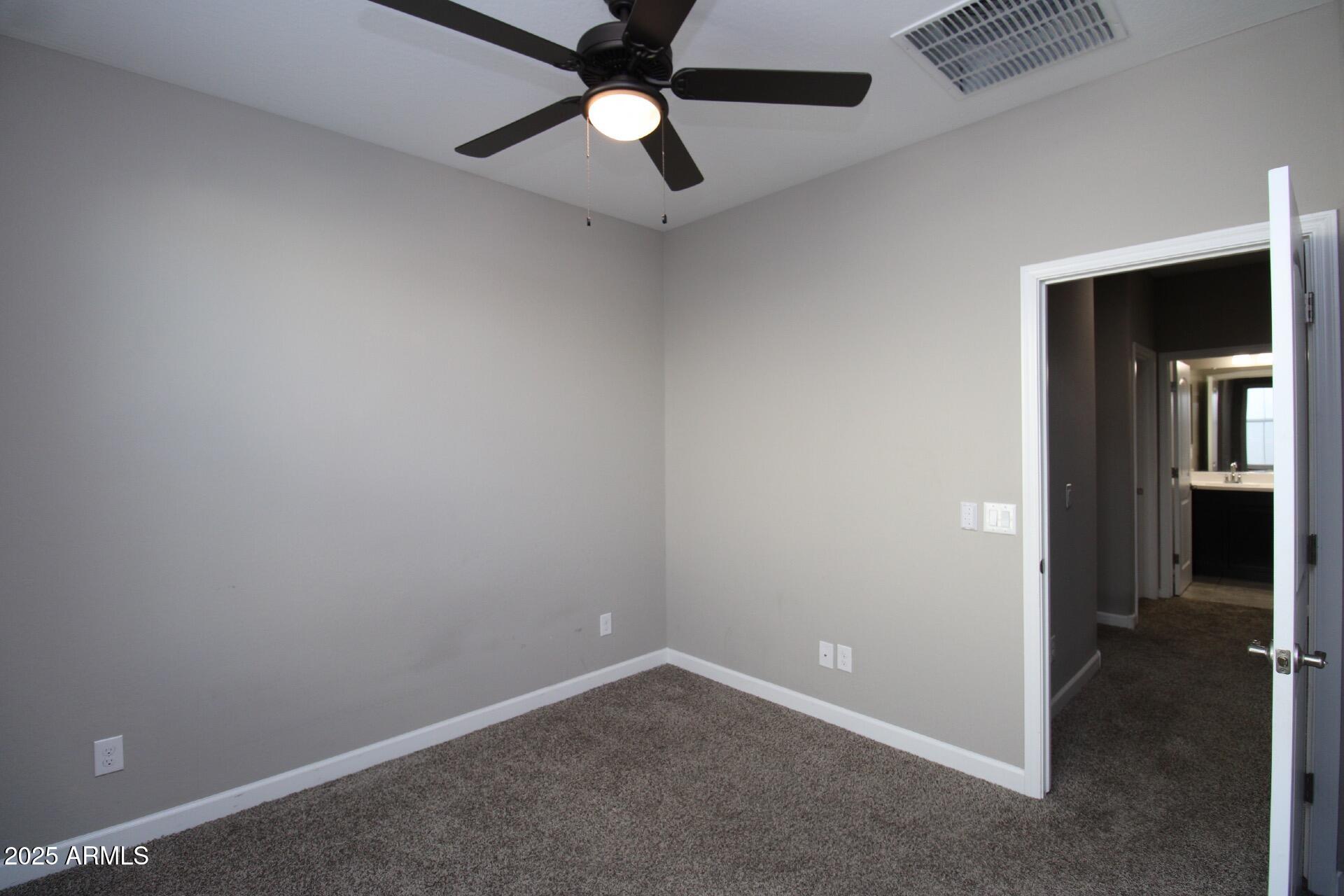1255 North Arizona Avenue, Unit 1269 Chandler, AZ 85225 - Photo 11 of 29 en empty room with closet and a chandelier fan