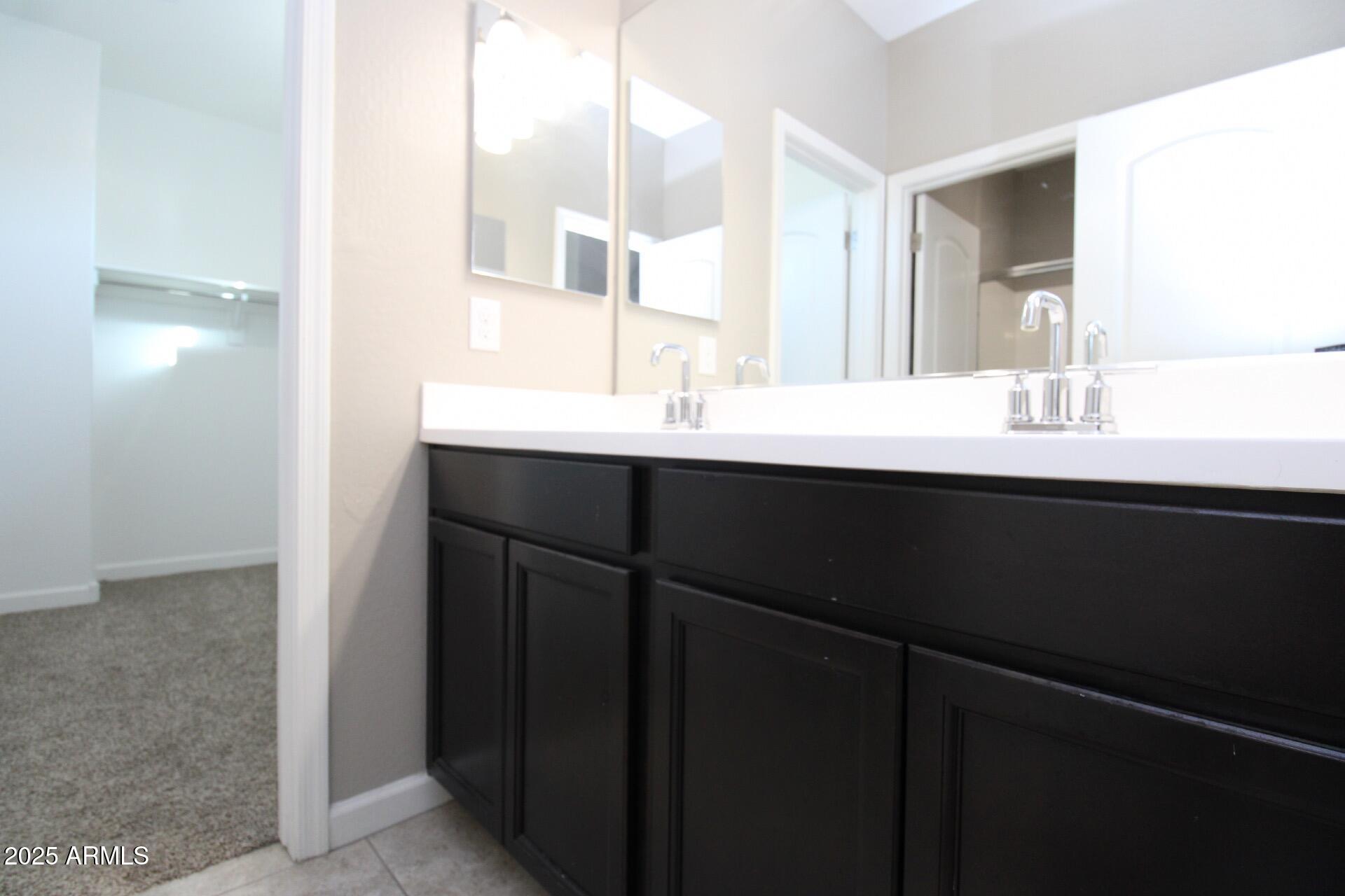 1255 North Arizona Avenue, Unit 1269 Chandler, AZ 85225 - Photo 12 of 29 a bathroom with a sink and a mirror