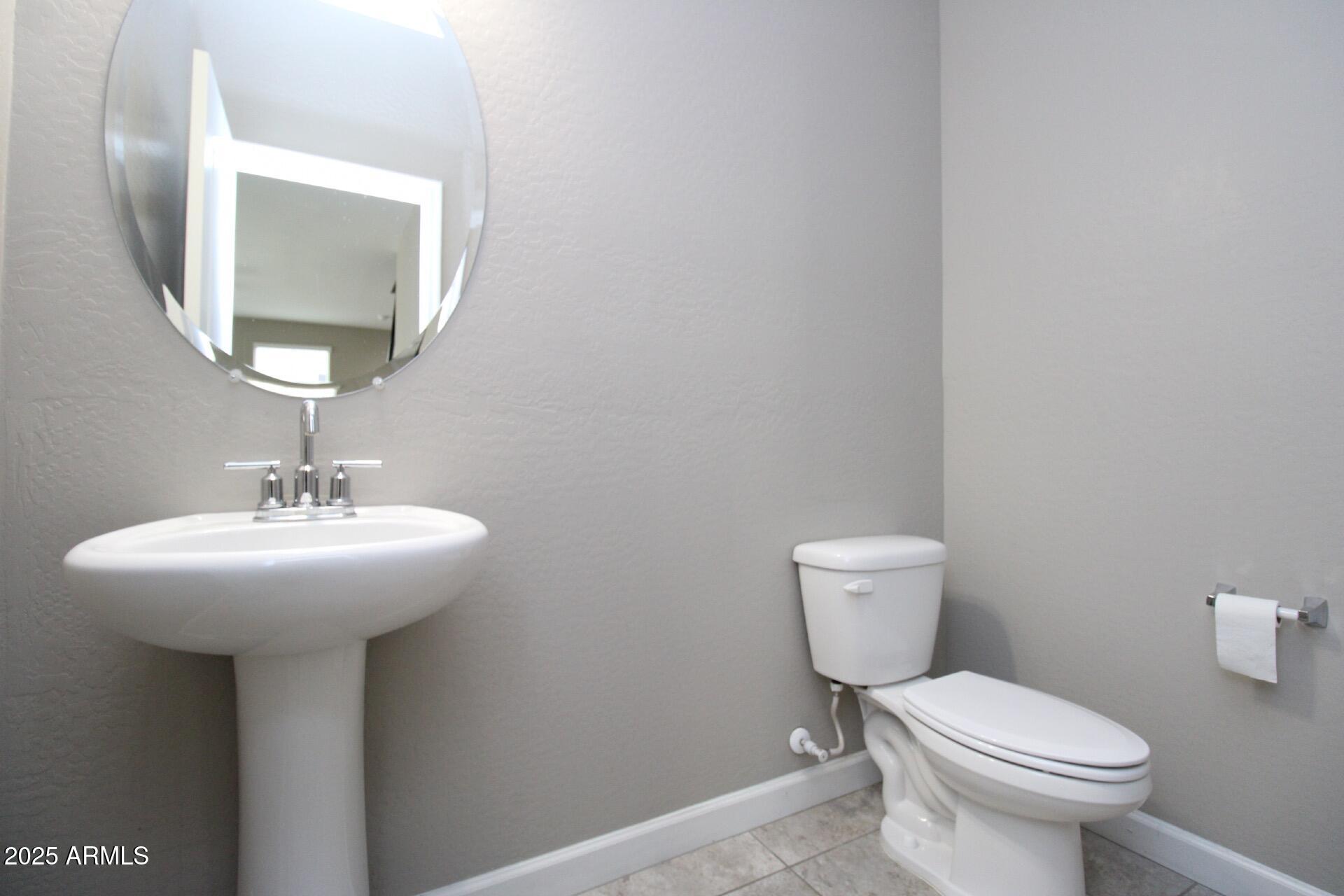 1255 North Arizona Avenue, Unit 1269 Chandler, AZ 85225 - Photo 14 of 29 a bathroom with a toilet sink and mirror
