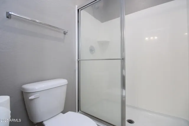 a white toilet sitting next to a bath tub