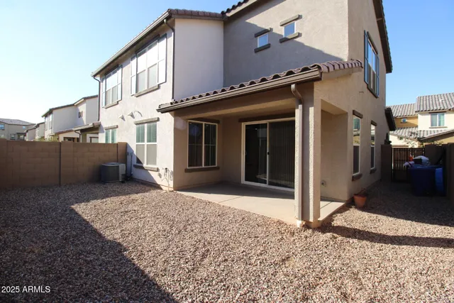 a view of a house with a barbeque and bench