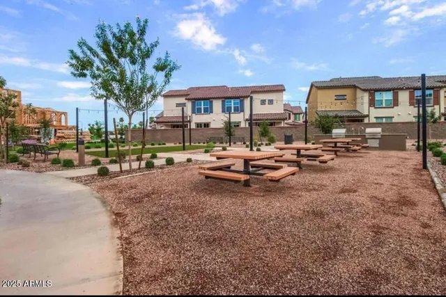 a row of palm trees sitting in front of a building