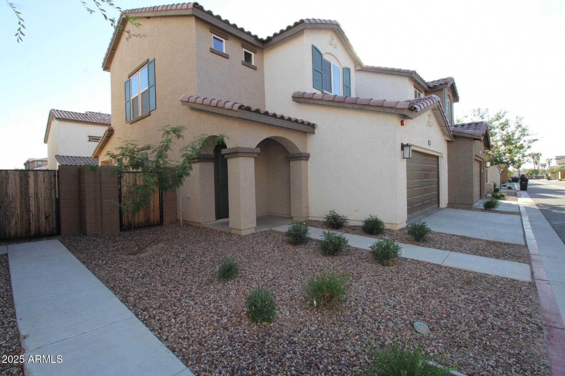 1255 North Arizona Avenue, Unit 1269 Chandler, AZ 85225 - Photo 2 of 29 a view of a house with a yard