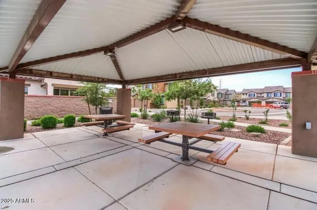 a building outdoor space with patio furniture and potted plants