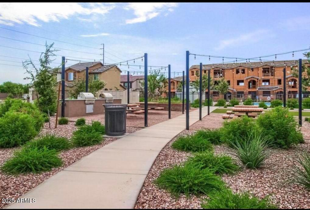 1255 North Arizona Avenue, Unit 1269 Chandler, AZ 85225 - Photo 26 of 29 a view of a patio with a table and chairs potted plants