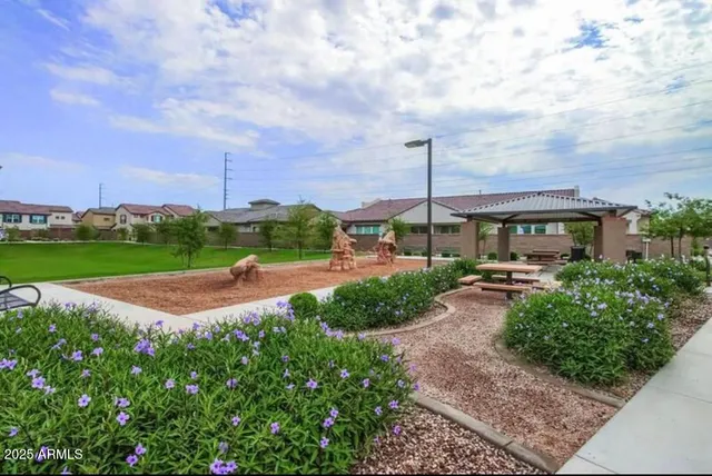 a view of a garden with a table and chairs