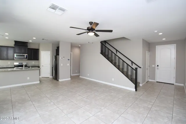 a view of a kitchen with furniture and a ceiling fan