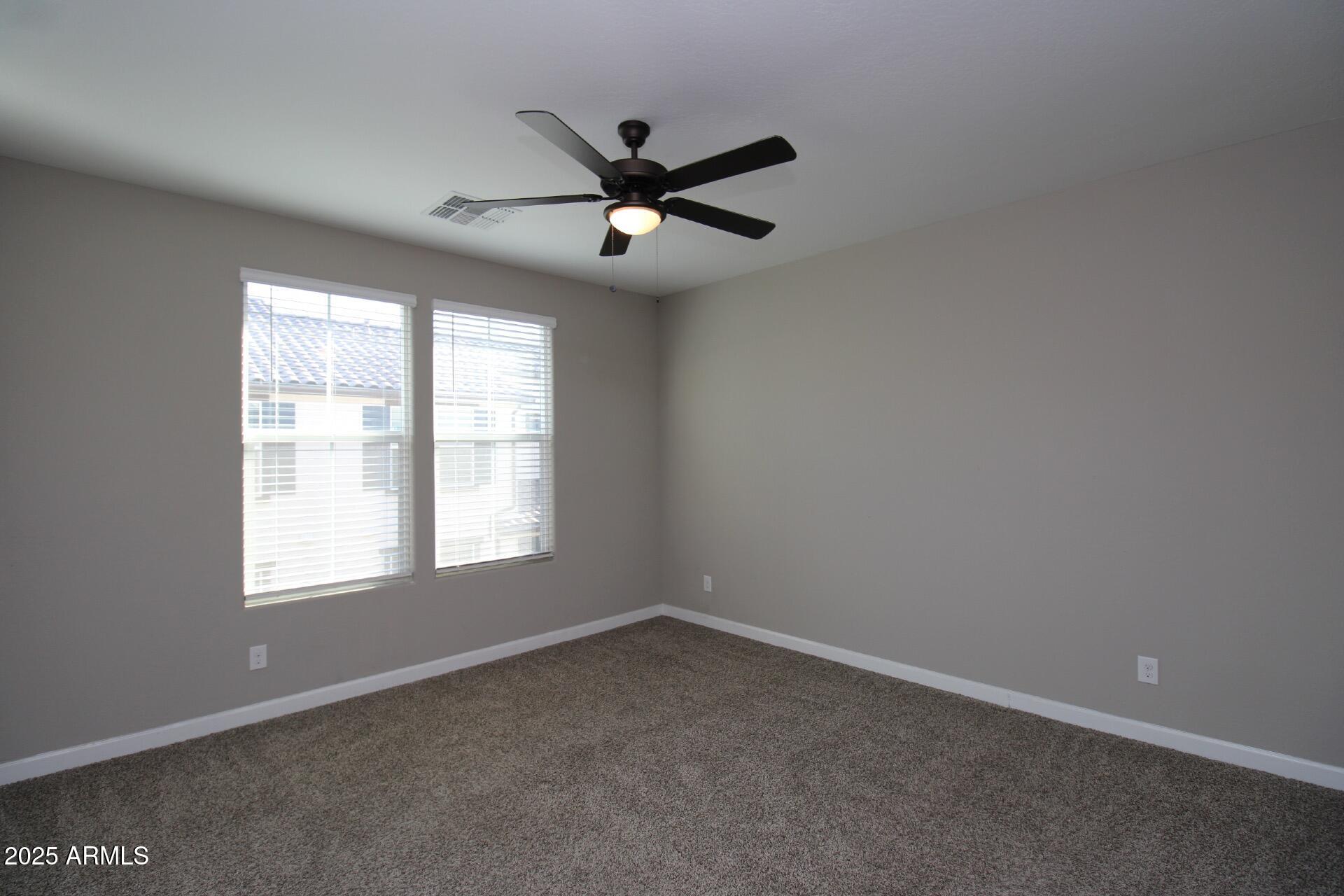 1255 North Arizona Avenue, Unit 1269 Chandler, AZ 85225 - Photo 7 of 29 an empty room with windows and fan