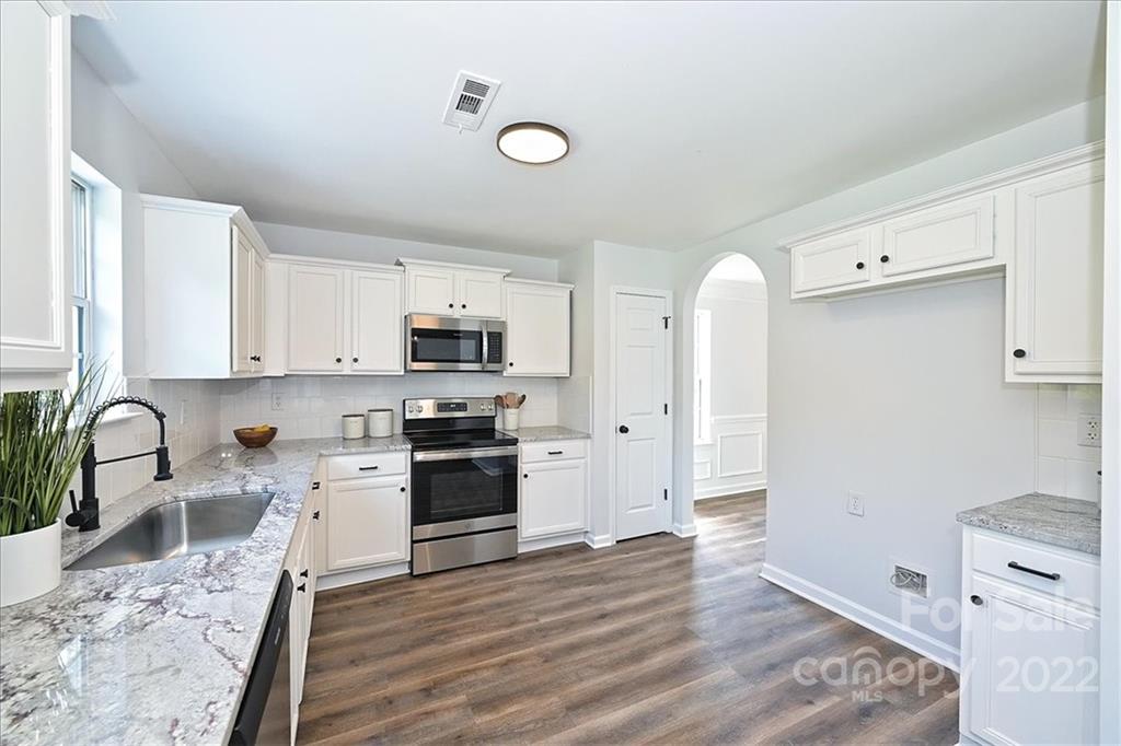 675 Winding Branch Road Rock Hill, SC 29732 - Photo 11 of 34 a kitchen with granite countertop a stove a sink and a refrigerator
