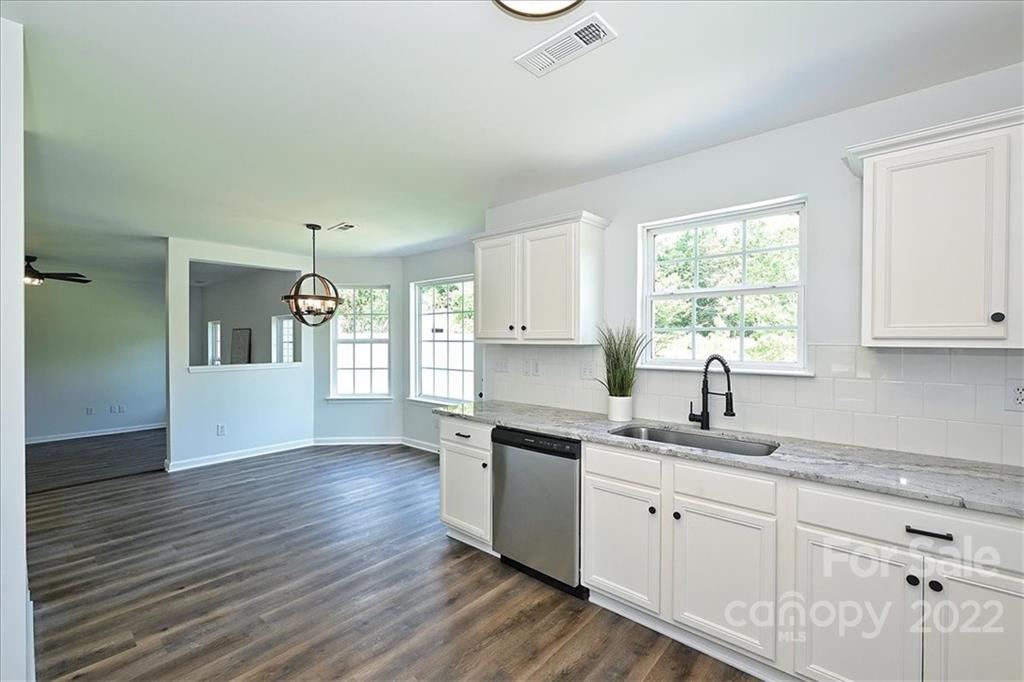675 Winding Branch Road Rock Hill, SC 29732 - Photo 13 of 34 a kitchen with granite countertop stainless steel appliances a sink window and cabinets