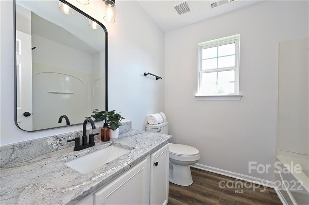 675 Winding Branch Road Rock Hill, SC 29732 - Photo 31 of 34 a bathroom with a granite countertop sink toilet and mirror