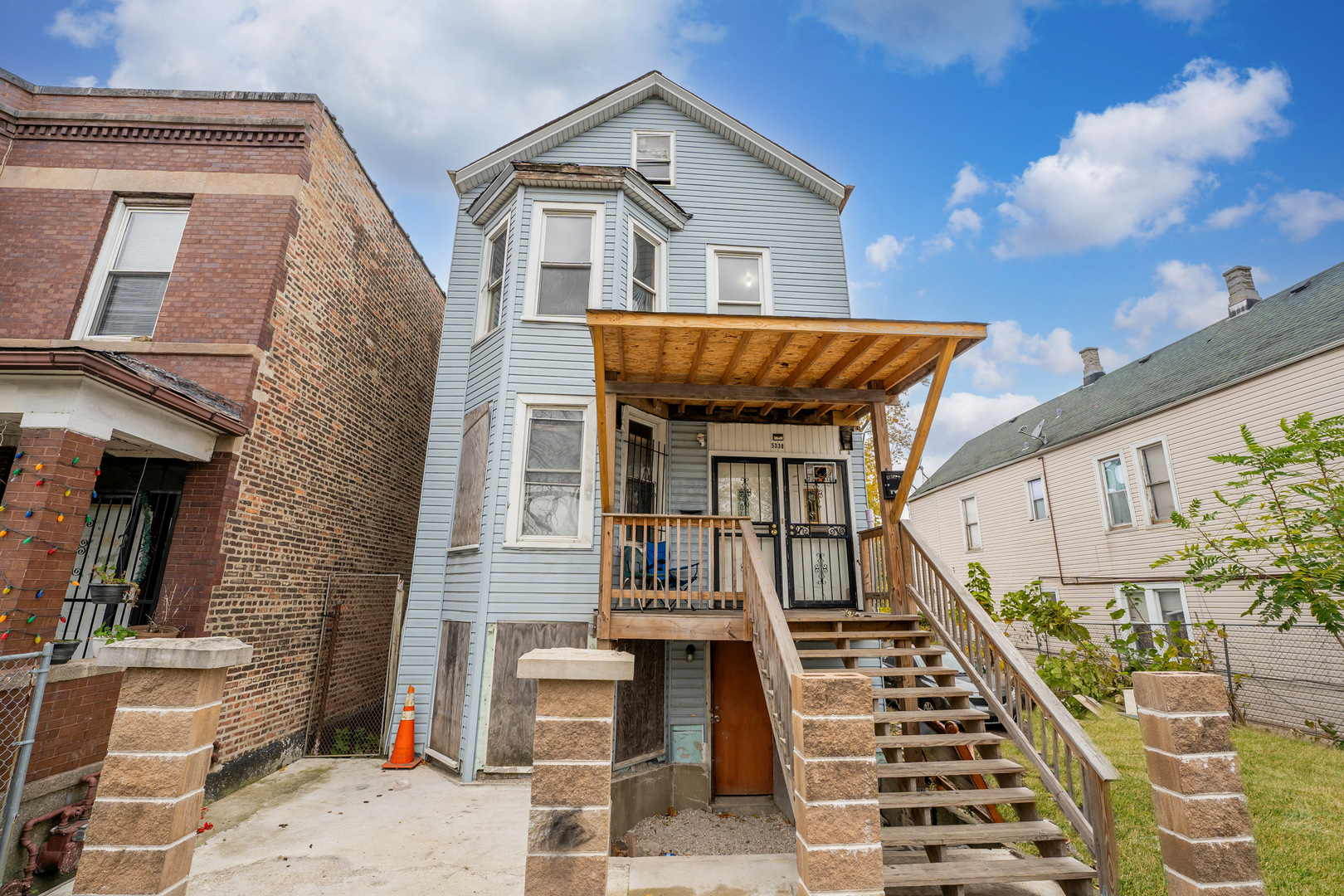 5338 South Wood Street Chicago, IL 60609 - Photo 1 of 22 a front view of a house with wooden stairs
