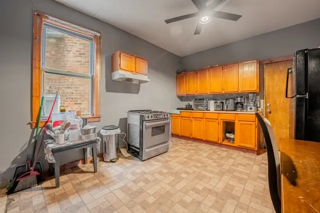 a kitchen with stainless steel appliances granite countertop a stove a sink and a refrigerator