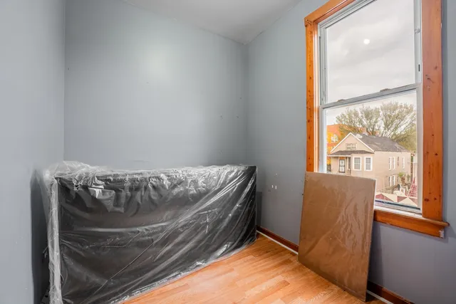 a living room with hard wood floors and a window