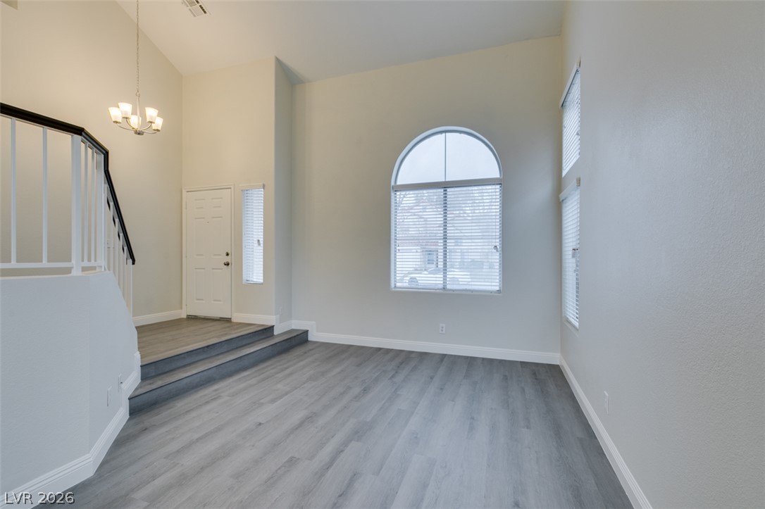 1738 Toltec Circle Henderson, NV 89014 - Photo 12 of 46 Lofty ceilings and a graceful arched window illuminate this inviting, open-concept living space.