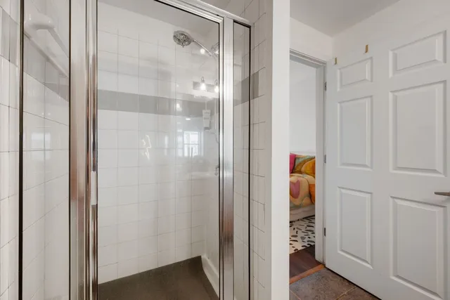 a bathroom with a shower and a sink