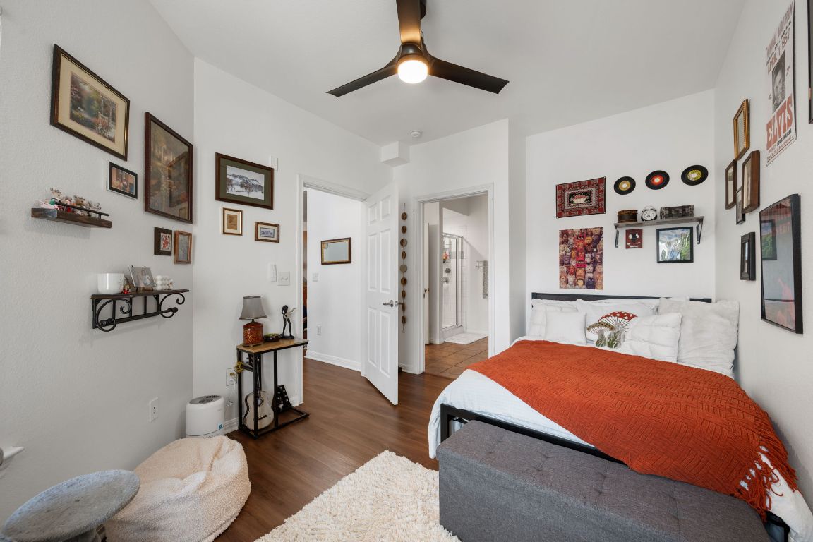 2502 Leon Street, Unit 511 Austin, TX 78705 - Photo 13 of 27 a bedroom with a bed and a chandelier