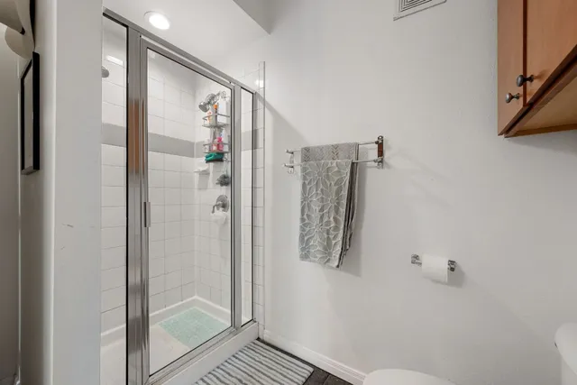a bathroom with a shower and a sink