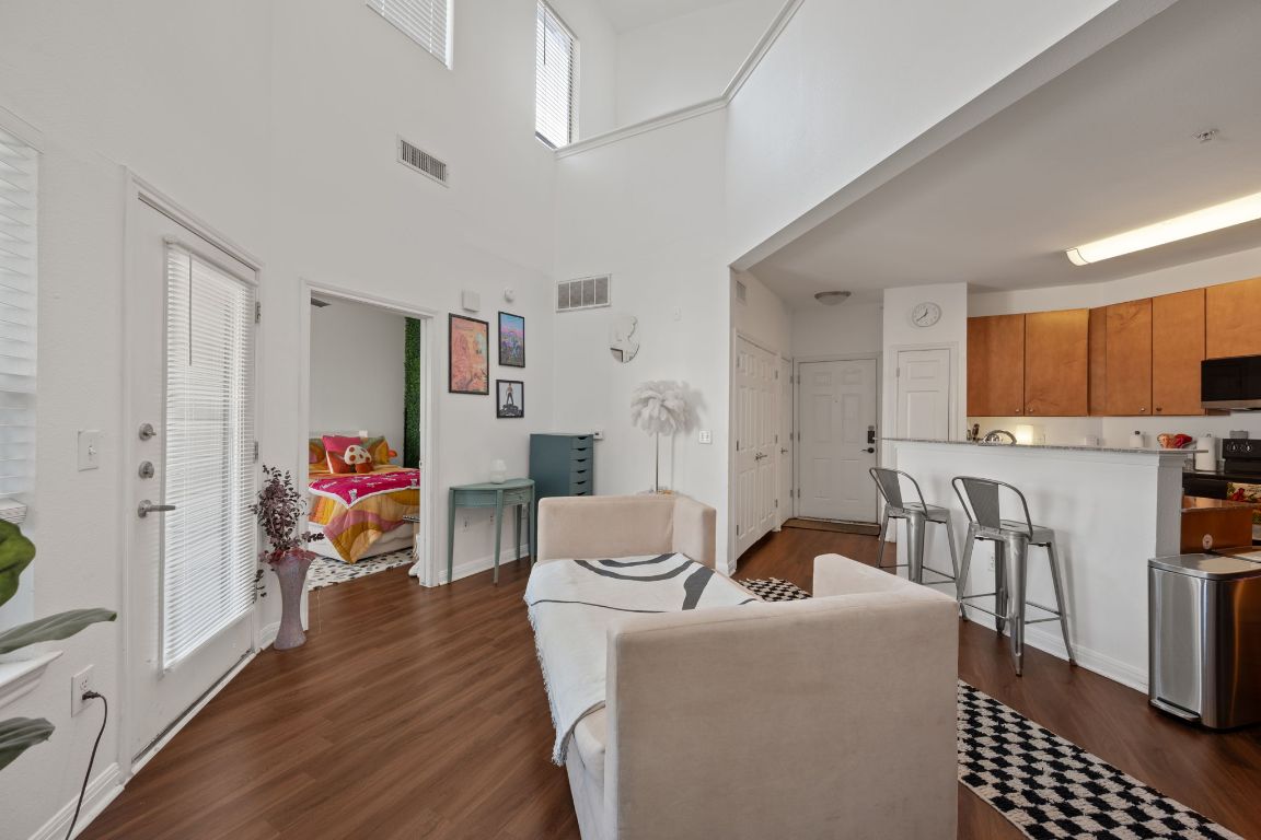 2502 Leon Street, Unit 511 Austin, TX 78705 - Photo 4 of 27 a living room with furniture and a dining table with kitchen view