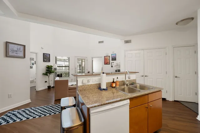 a kitchen with stainless steel appliances granite countertop a sink stove and cabinets