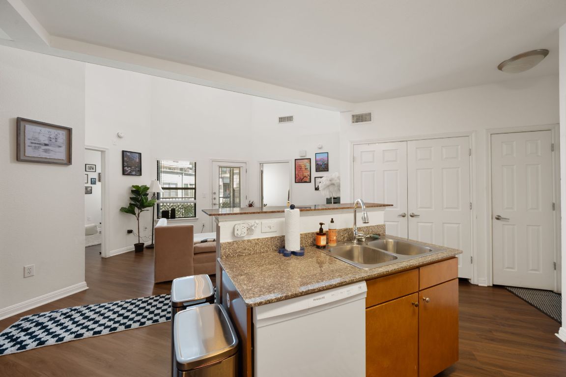 2502 Leon Street, Unit 511 Austin, TX 78705 - Photo 7 of 27 a kitchen with stainless steel appliances granite countertop a sink stove and cabinets