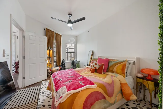 a bedroom with a bed and a chandelier