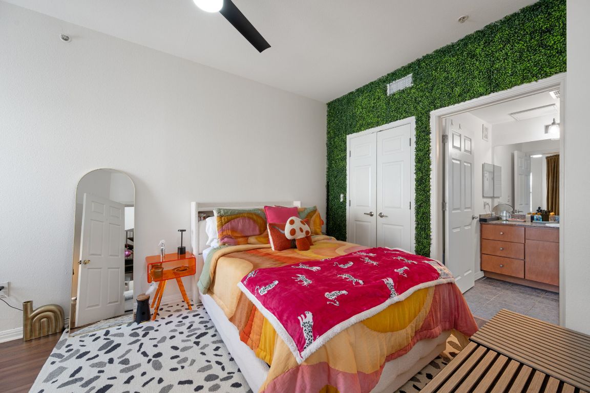 2502 Leon Street, Unit 511 Austin, TX 78705 - Photo 9 of 27 a bedroom with a bed and a chandelier