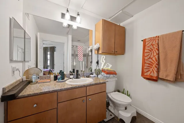 a bathroom with a toilet sink and mirror