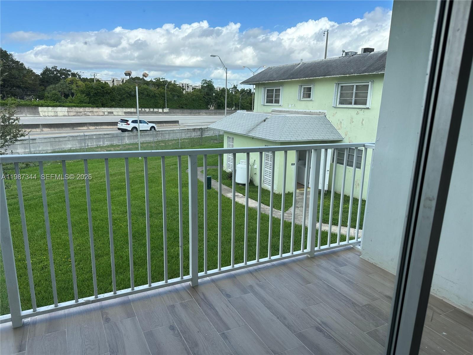 7670 Southwest 82nd Street, Unit H215 Miami, FL 33143 - Photo 9 of 9 a front view of a house with a yard