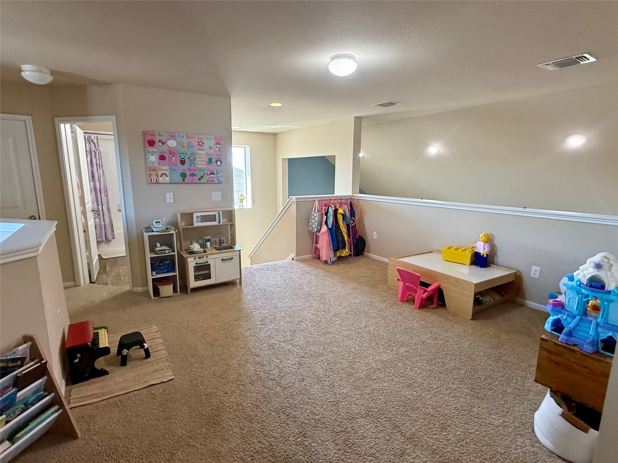 11700 Andesite Road Manor, TX 78653 - Photo 17 of 32 A spacious carpeted loft area provides a flexible play or relaxation zone.