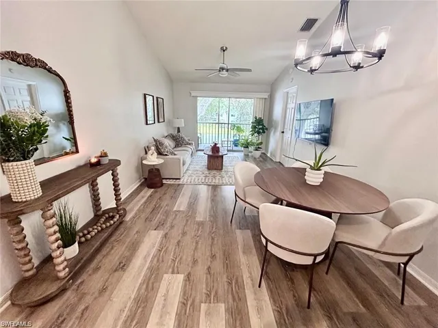 a living room with furniture a window and a chandelier