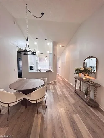 a dining room with furniture and wooden floor