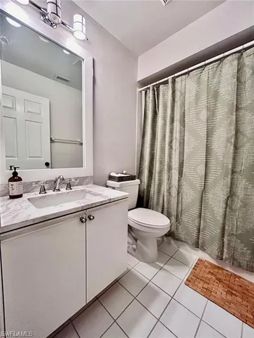 a bathroom with a toilet a sink and a mirror