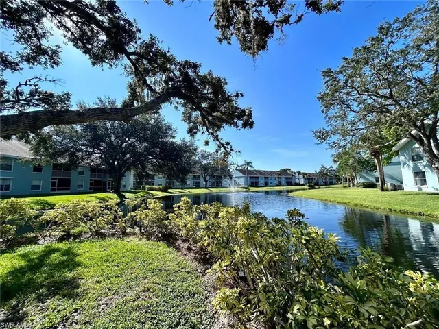 a view of a lake with a house in the background