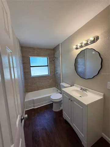 a bathroom with a toilet a sink and bathtub