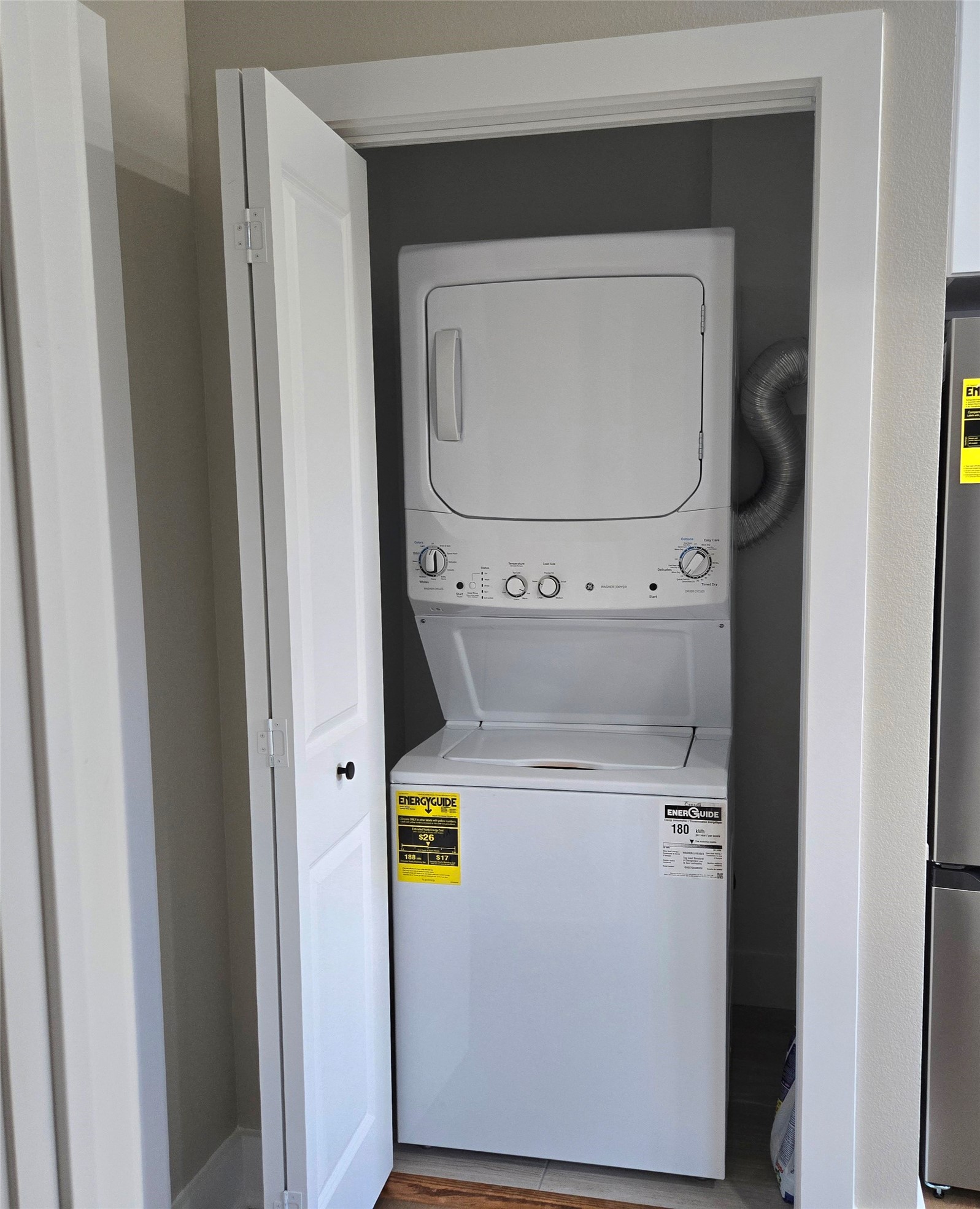 7830 Woodlyn Road, Unit B Houston, TX 77028 - Photo 9 of 10 Convenient laundry closet with a stacked washer and dryer, offering efficient use of space and easy access.