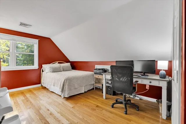 a bedroom with a bed and a chair