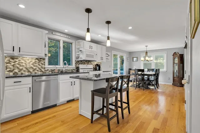 a kitchen with lots of counter top space and dining table chairs